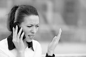 Upset woman having unpleasant conversation on a phone